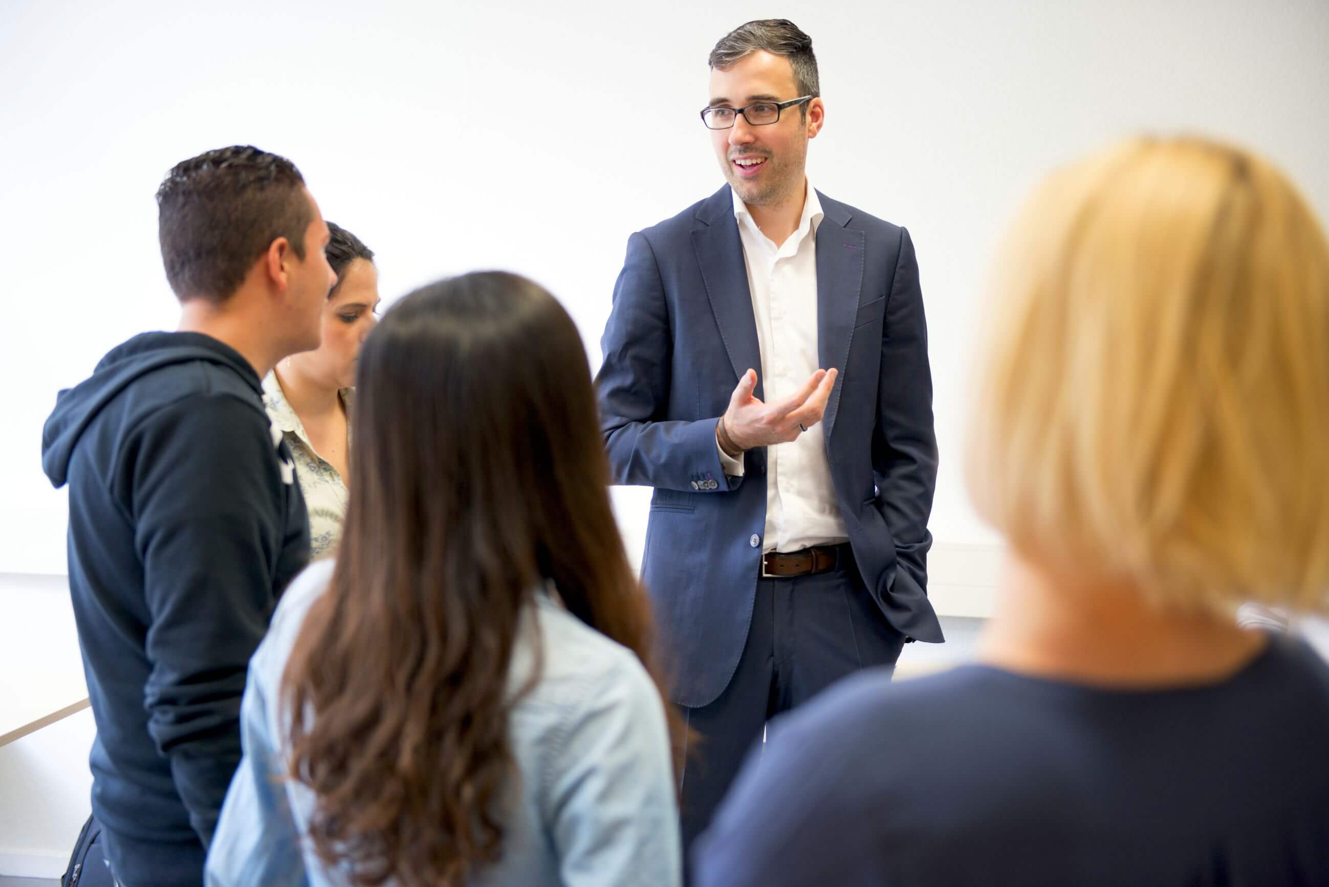 Imre Végh facilitating a small-group leadership coaching session with diverse participants